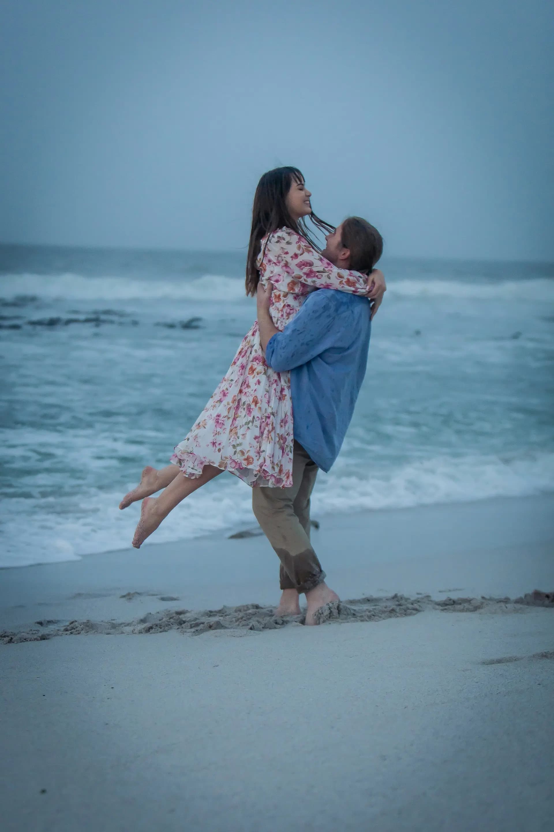 Couple embracing on a beach at dusk