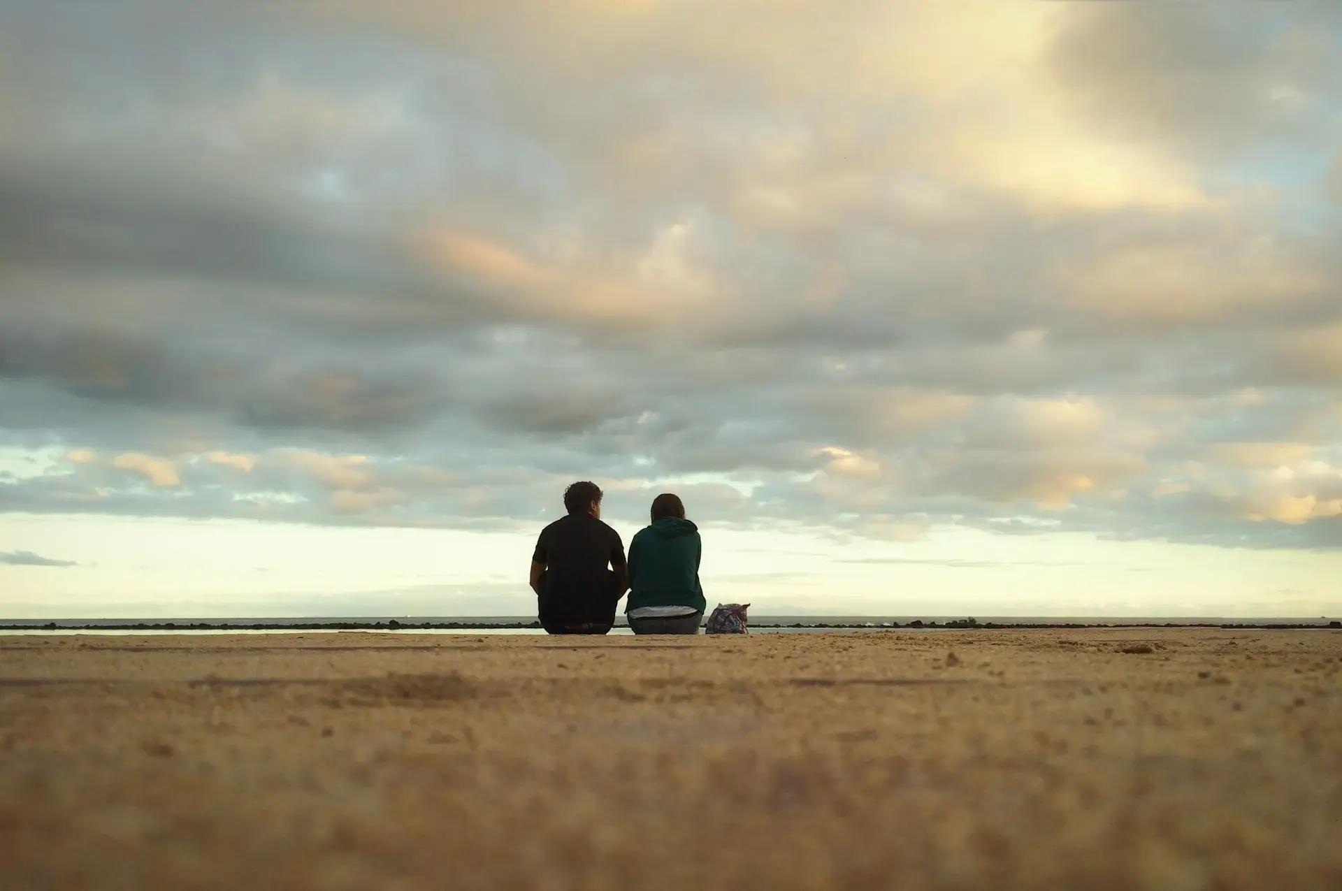 Couple watching sunset over the sea in Cartagena