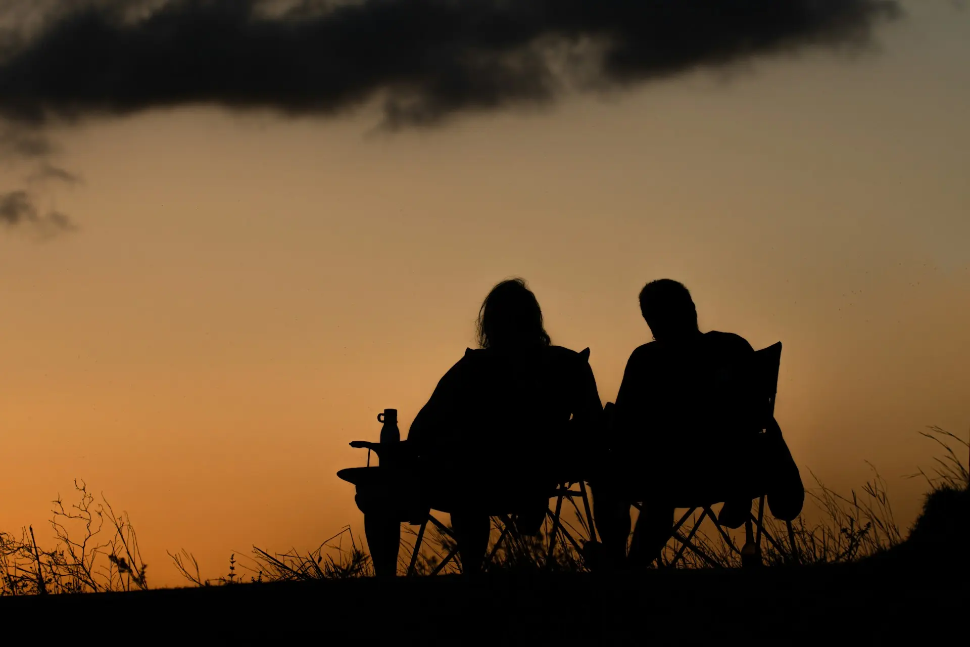 Couple silhouette at a dramatic amber sunset